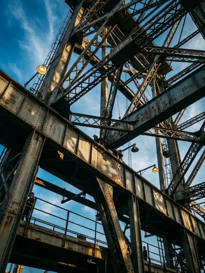 rusty steel bridge structure blue sky